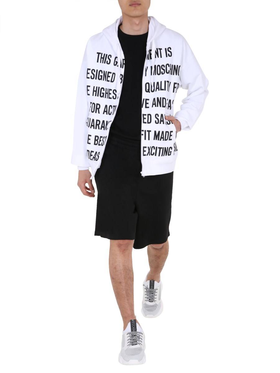 MOSCHINO FELPA IN COTONE CON ZIP E STAMPA SLOGAN