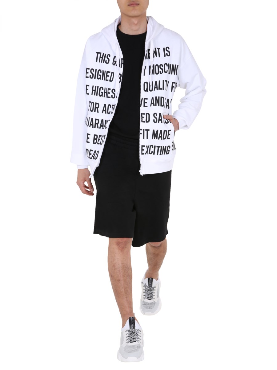 MOSCHINO FELPA IN COTONE CON ZIP E STAMPA SLOGAN