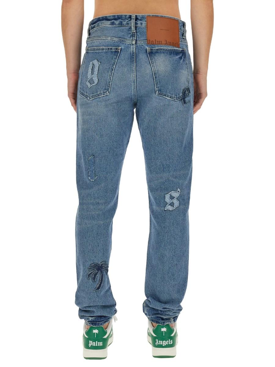 PALM ANGELS JEANS A CINQUE TASCHE CON PATCH LOGO