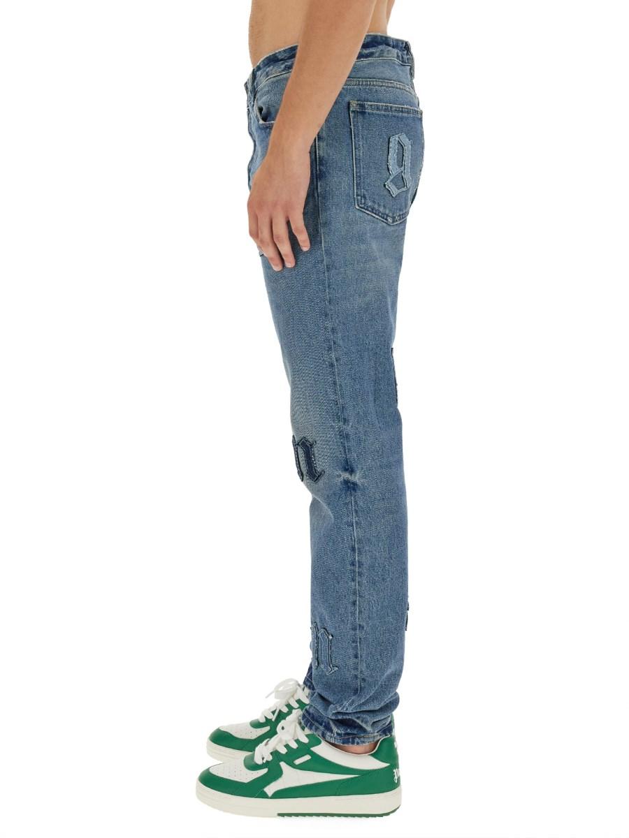 PALM ANGELS JEANS A CINQUE TASCHE CON PATCH LOGO
