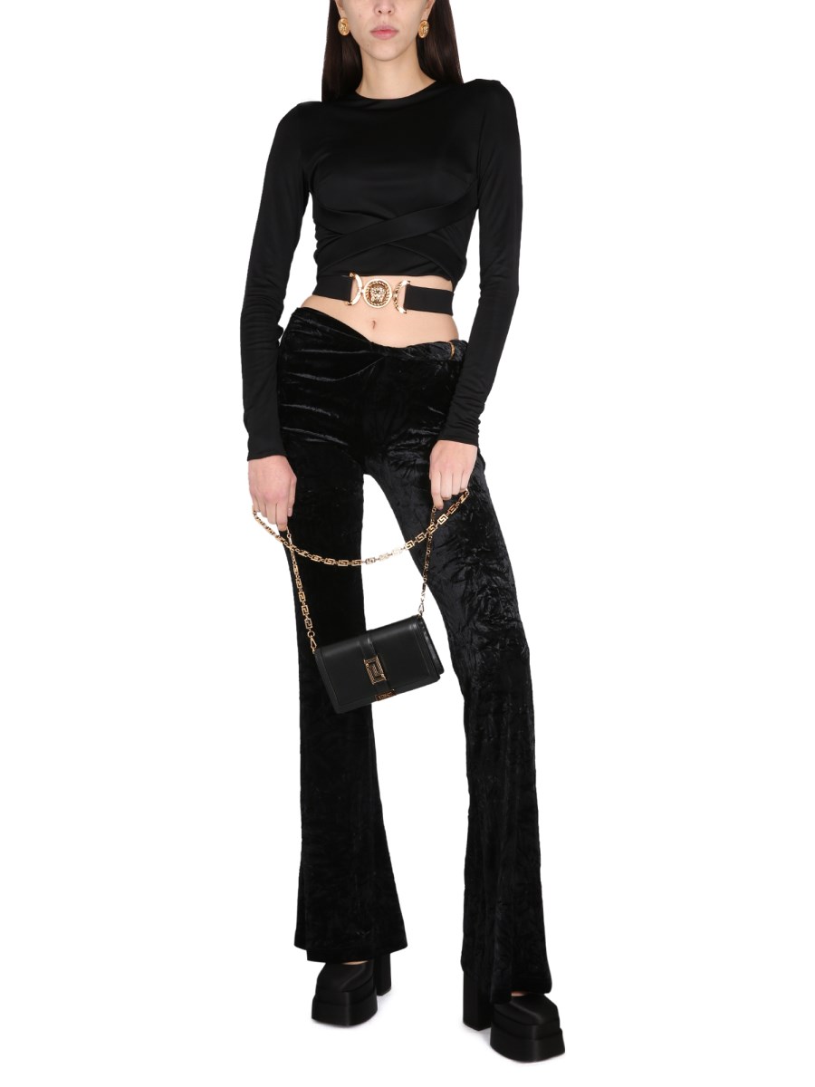 VERSACE PANTALONE SVASATO IN VELLUTO ARROTOLATI