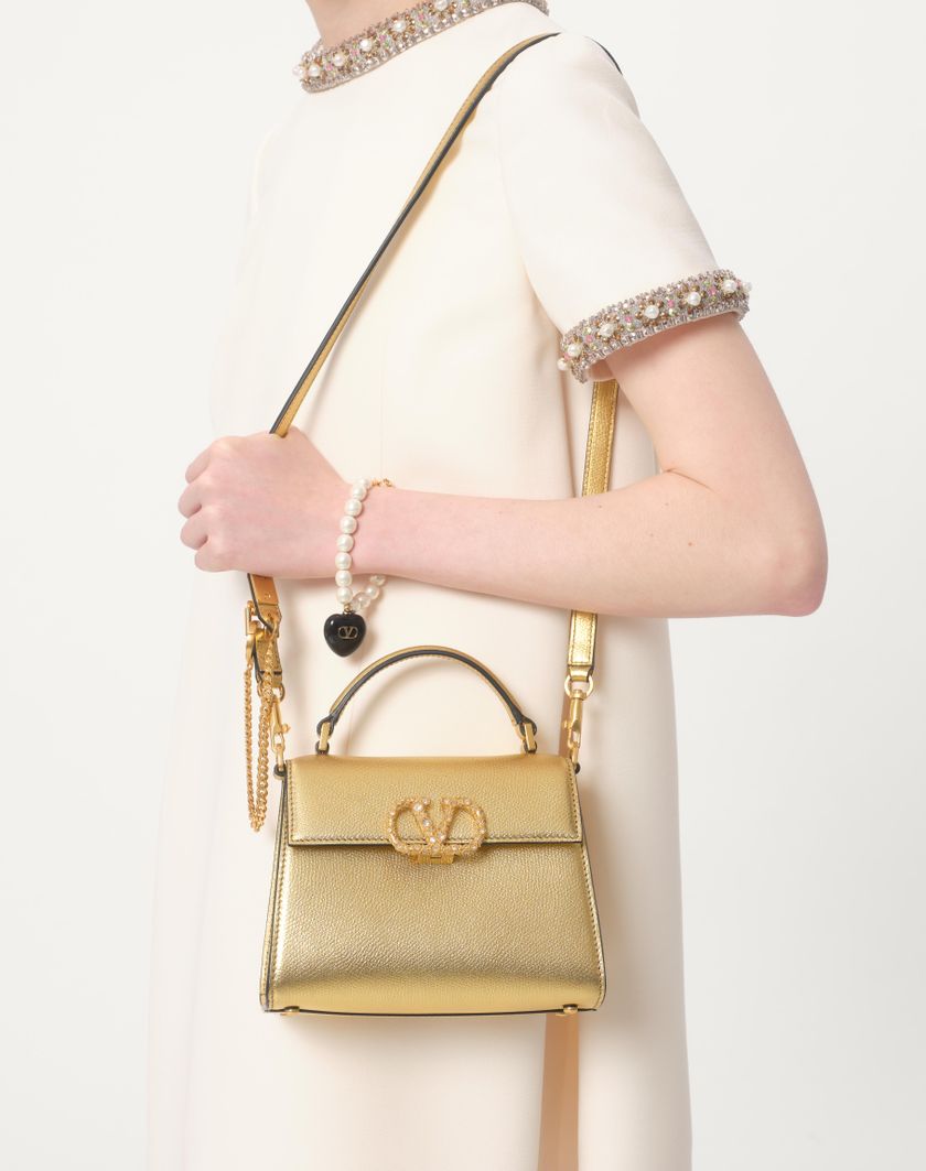 Valentino Handbags Borsa A Mano Mini Valentino Garavani Vsling In Vitello Granato Laminato Con Logo Gioiello Per Donna In Antique Brass | Valentino IT